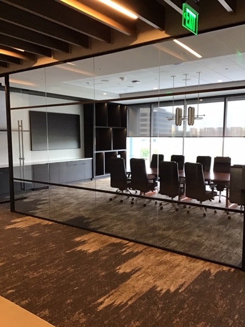 Large conference room with a mounted 98-inch television display