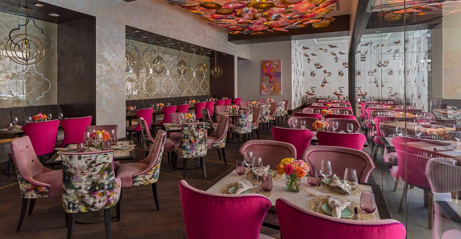 Restaurant dining area with bright pink modern seating.