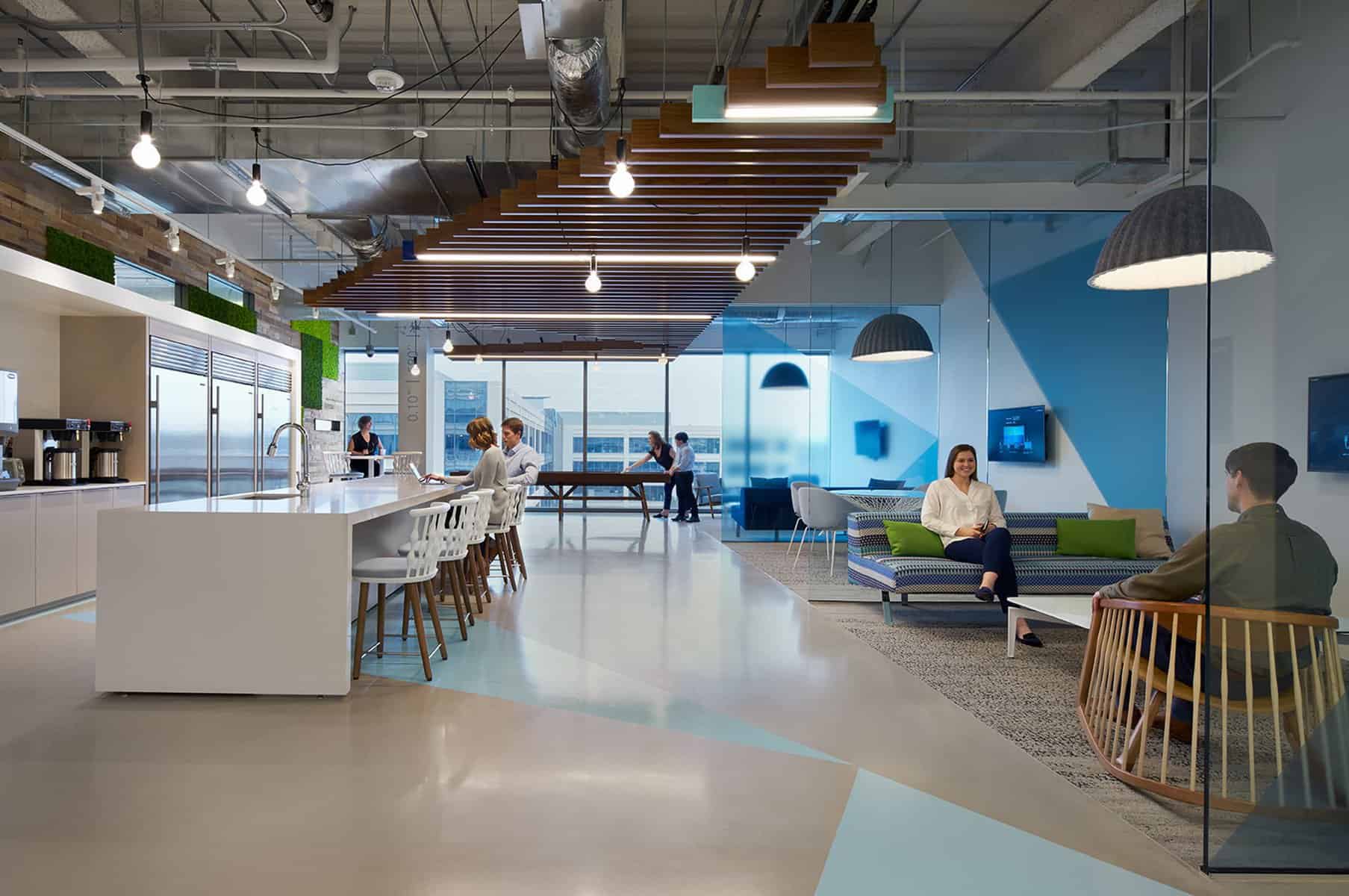 Employee breakroom with corporate digital signage at tables.