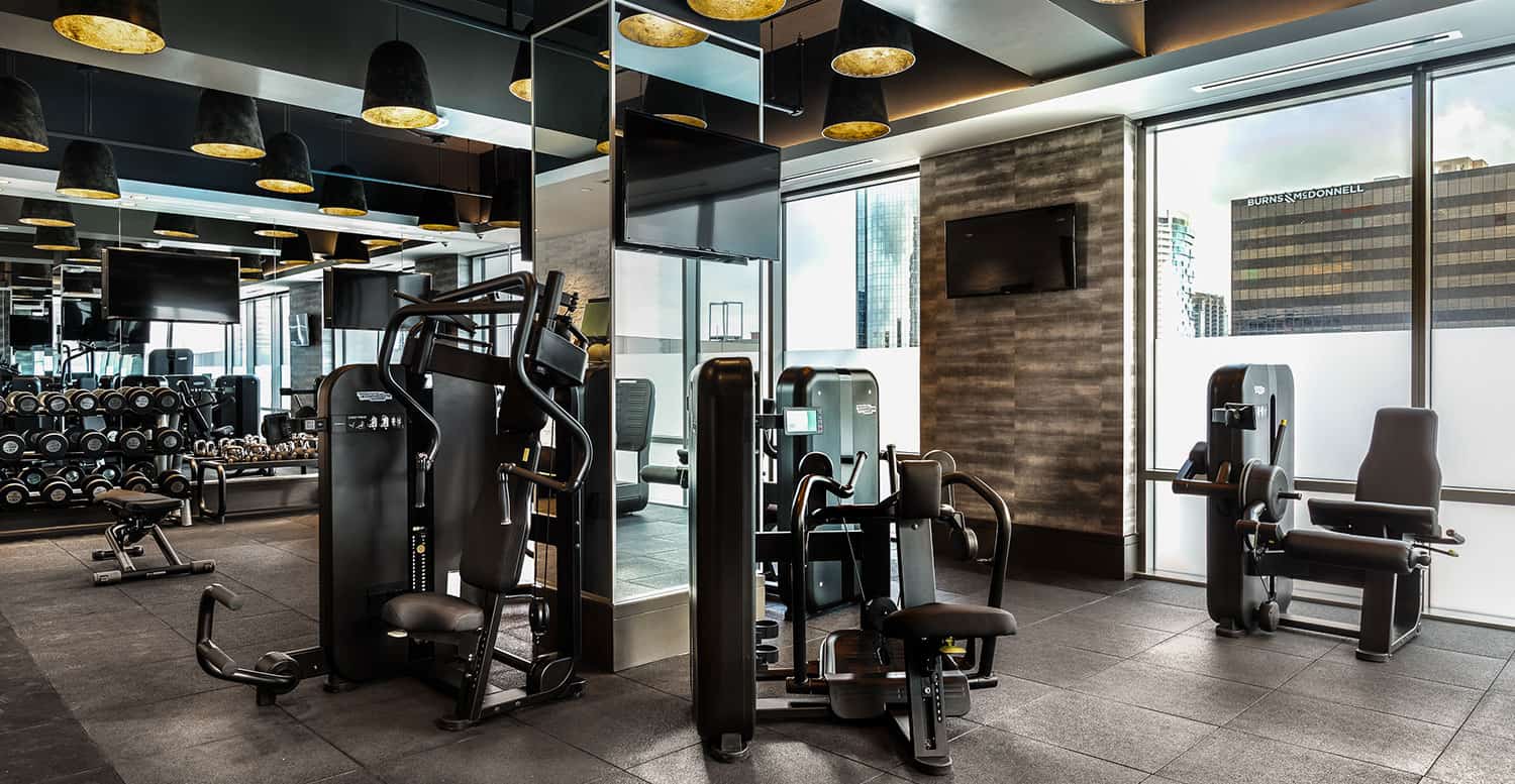 Weight machines and television in a hotel gym.