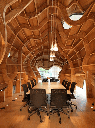 Conference room with curved wood on the walls.