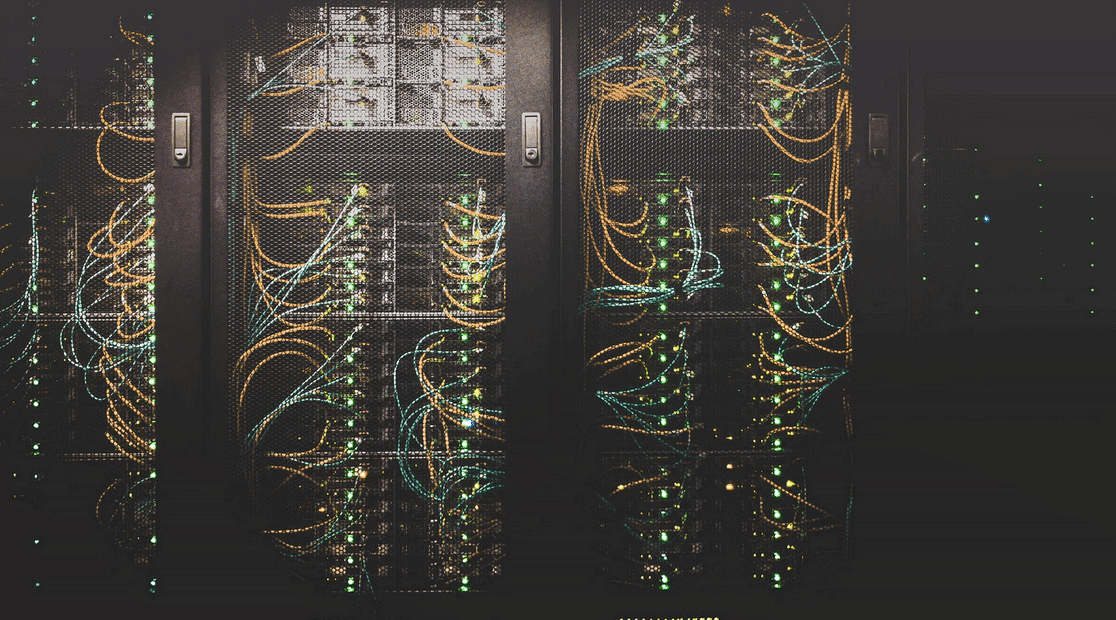 Data center cabinets with racks and cables organized.