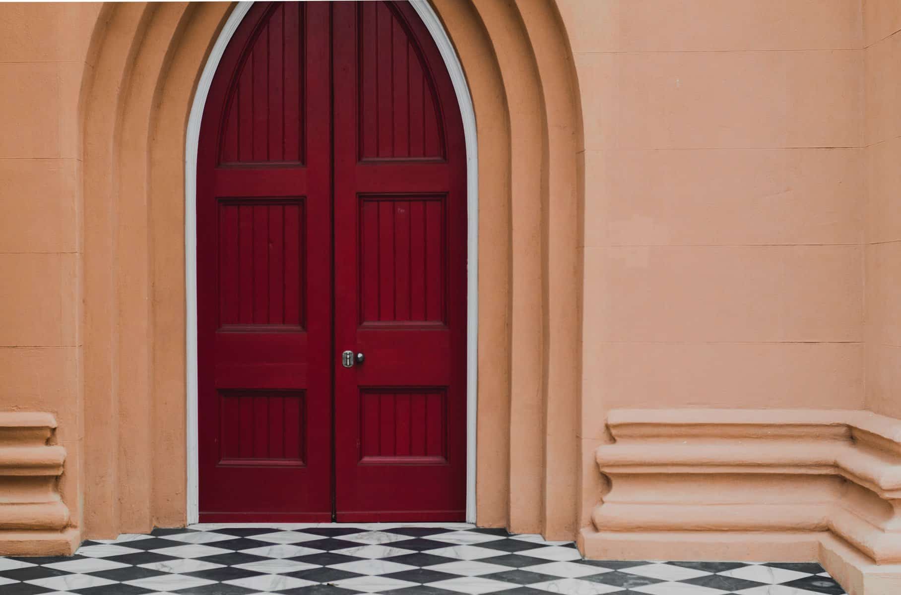 Large red church doors securing the exterior.