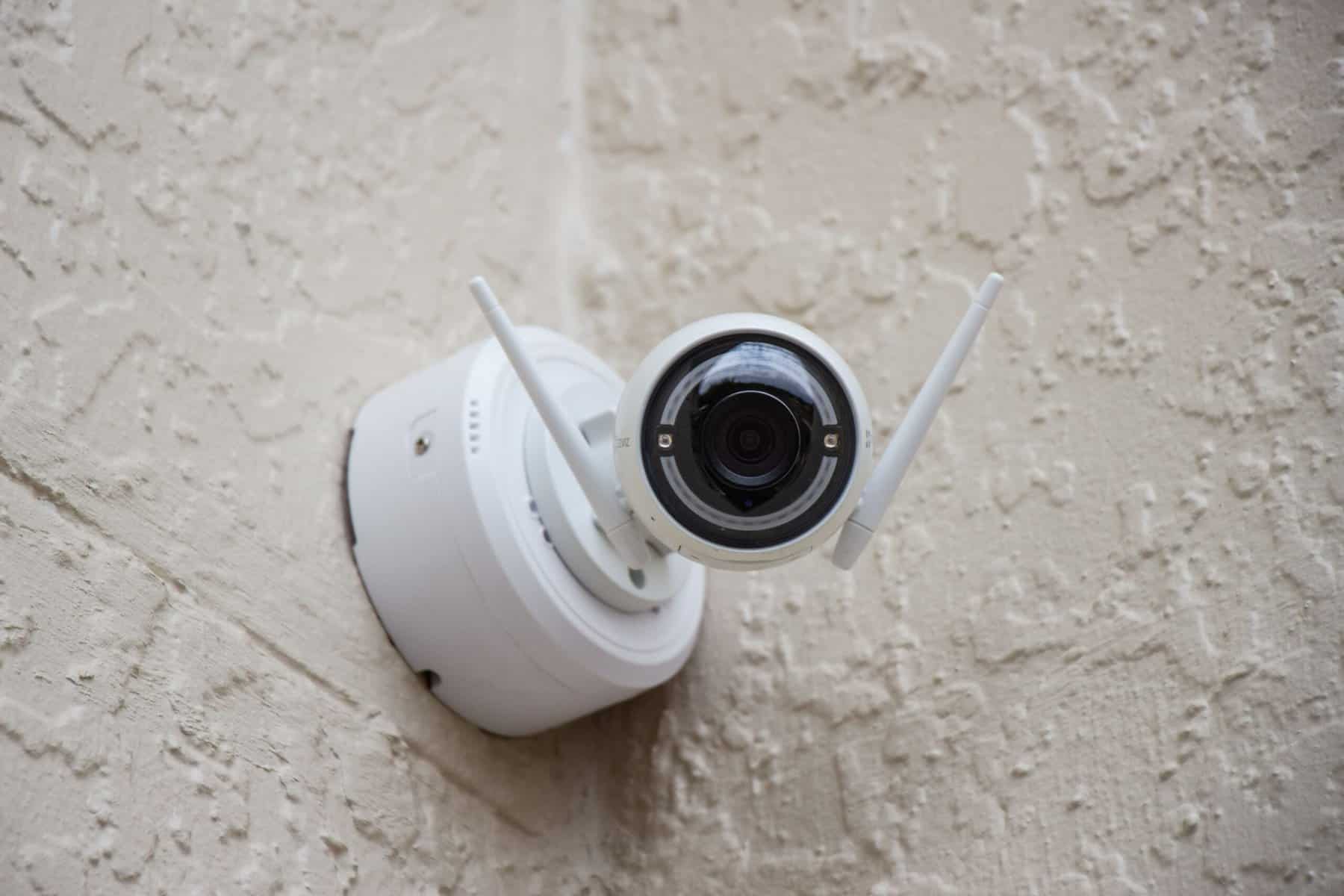 A wireless security camera mounted to a wall.