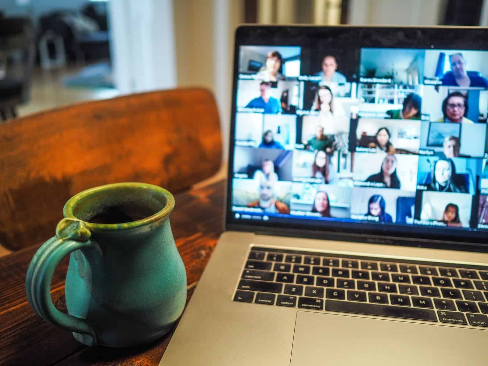 Remote worked laptop with a zoom meeting open on a laptop.