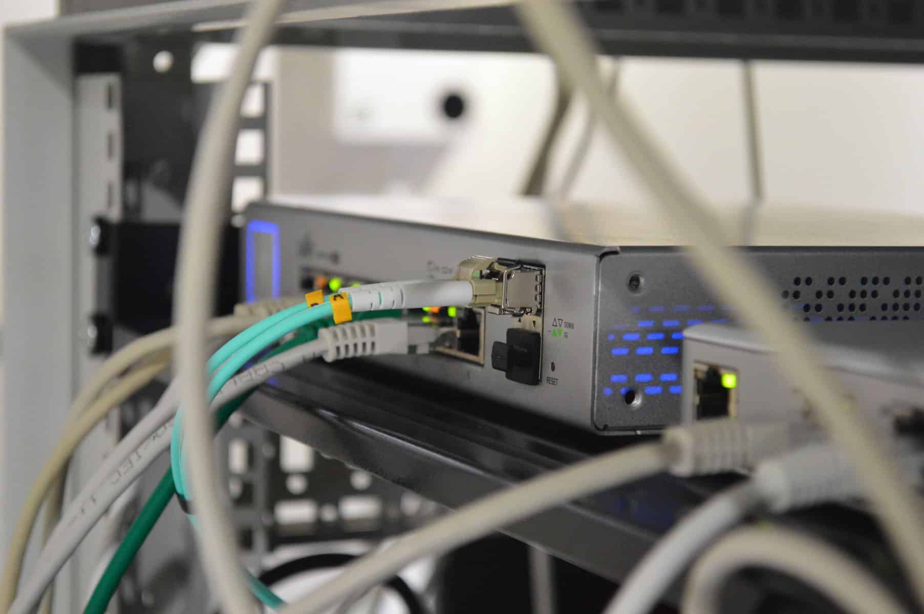 A commercial grade router sitting on a network rack.